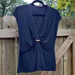 Stretchy black Roberto Cavalli top with metal/rhinestone accent.